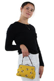 Bees Kisslock Bag in Yellow Cotton, handheld style on model