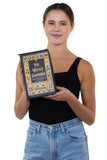 The Witches Companion Book Bag in Vinyl, front view, handheld by model