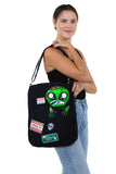 Peeking Alien Canvas Messenger Bag, shoulder bag style on model