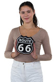 Route 66 Cross Body Bag in Vinyl Material, front view, handheld by model