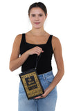 The Witches Companion Book Bag in Vinyl, wristlet style on model