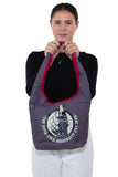 Officially Licensed Classic Glass Bottle Coca-Cola University Hobo Bag, front view, handheld by model
