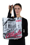 Officially Licensed Coca-Cola Nylon Tote Bag with Pre-1910 Atlanta Print, front view, handheld by model